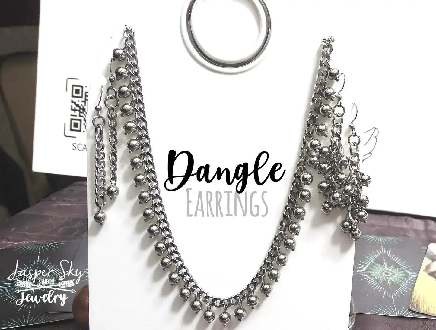 Silver dangle earrings and matching necklace set on display card. Elegant handcrafted jewelry gift for casual or chic wear.