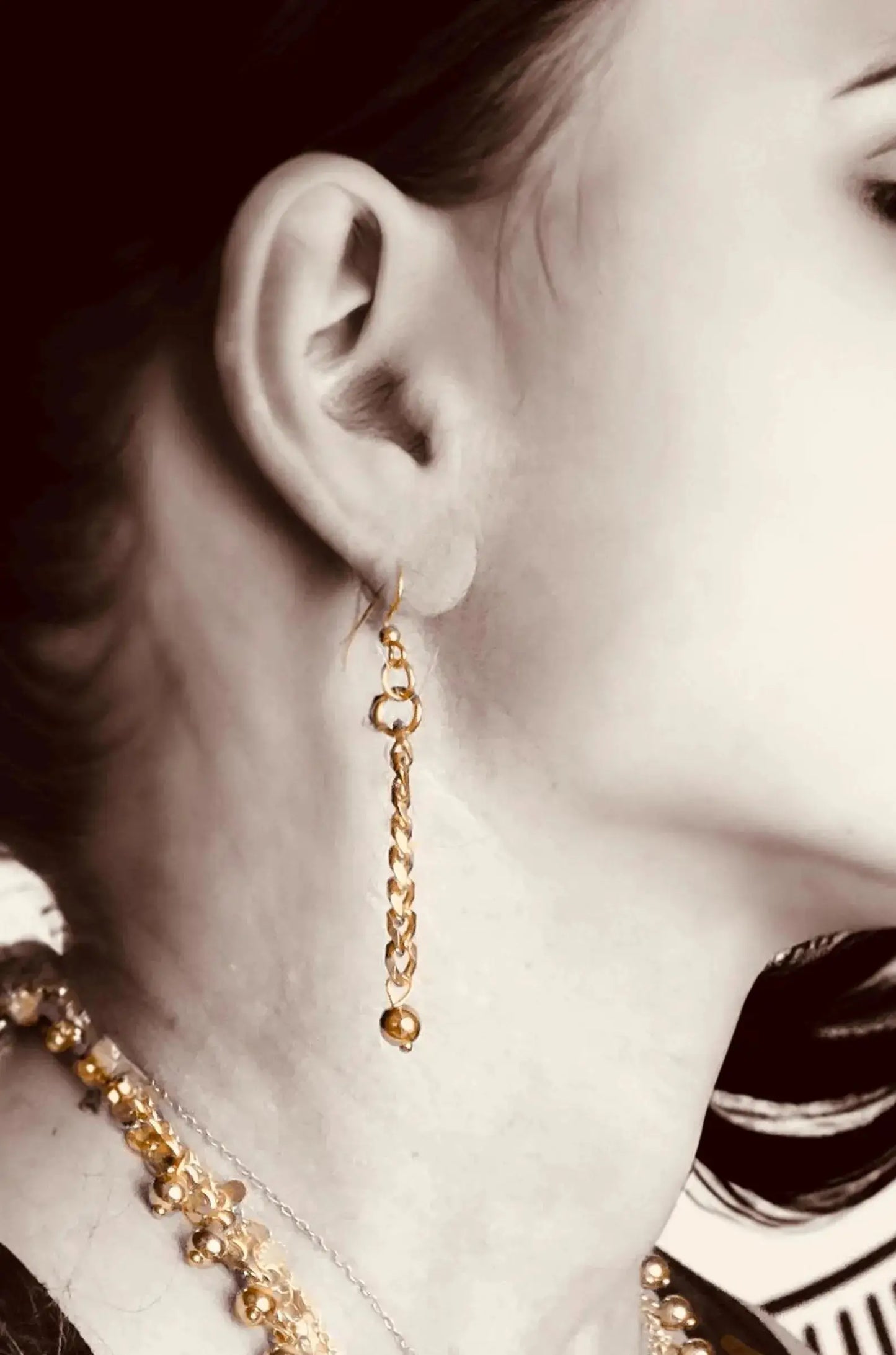 Side view of model wearing Handcrafted Gold Long Dangle Earrings, showcasing lightweight and stylish design for daily elegance.