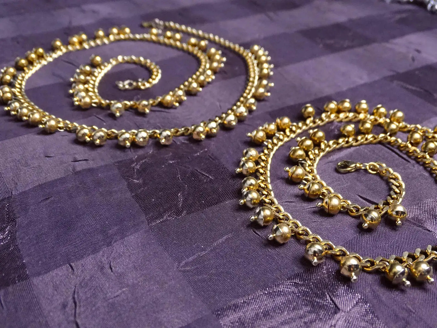 Matching gold necklaces with beaded detailing complementing the Handcrafted Gold Long Dangle Earrings, perfect for jewelry sets.