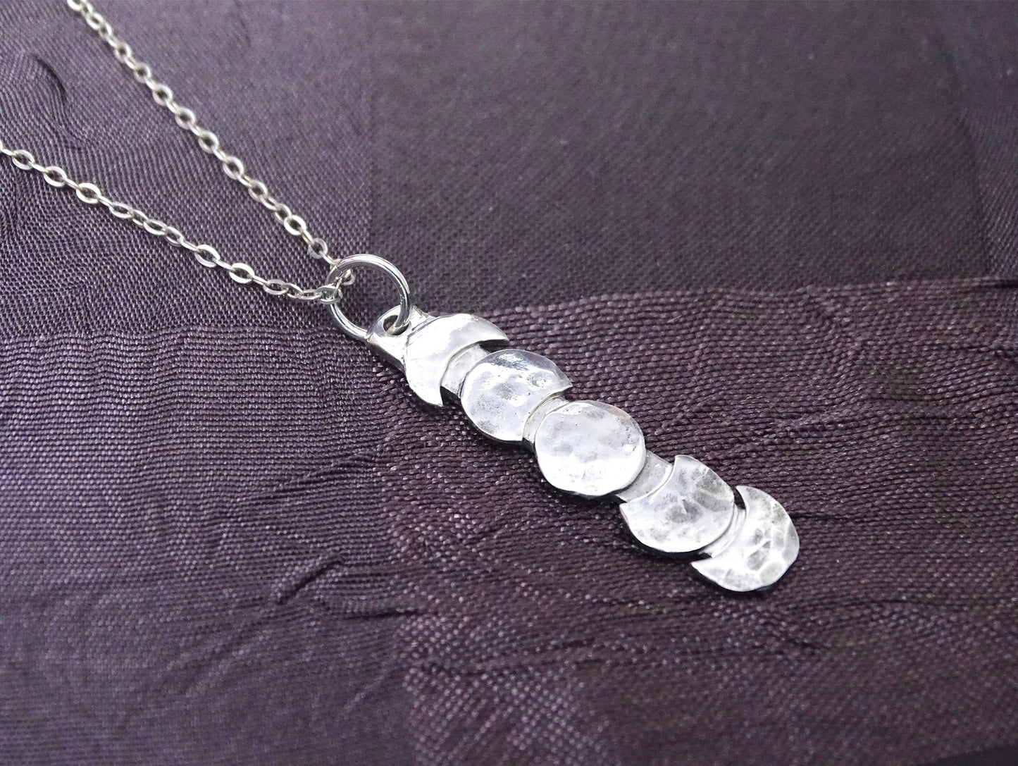 Handmade sterling silver moon phase necklace with vertical lunar design on hypoallergenic chain, ideal celestial jewelry gift for Christmas.