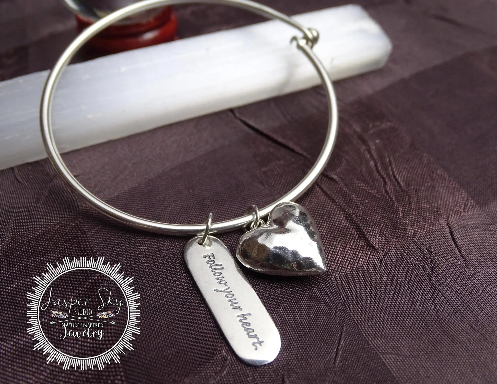 Sterling silver bracelet with hammered heart charm and engraved 'Follow your heart' tag, ideal inspirational Christmas gift for her.