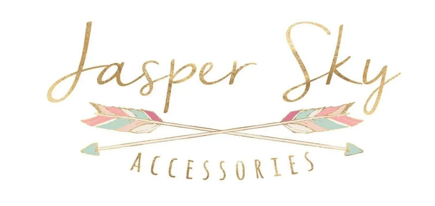 Jasper Sky Accessories logo with gold lettering and pastel arrows, representing the brand behind the tarot necklace collection.