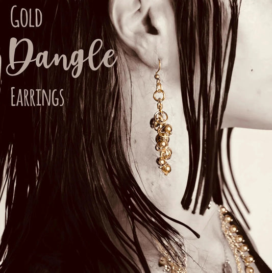 Close-up of model wearing clustered style Handcrafted Gold Long Dangle Earrings, ideal for chic and elegant fashion statements.