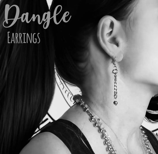 Handcrafted long silver dangle earrings worn with layered necklaces, perfect for casual or chic style. Elegant jewelry gift for women.